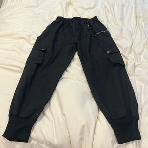 Shein black joggers with a detailed chain on the side